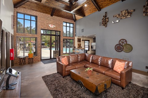 a living room with a leather couch and a coffee table